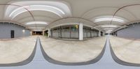 three different angles of an empty indoor skate park area as seen from the side of the building