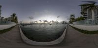 two fisheye views of a body of water with some buildings in the background at sunset