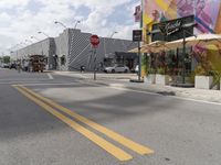 a empty city street that is surrounded by buildings and lots of decorations on the side of the road