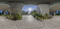 a circular panoramic view of a plaza near some high rise buildings and an open walkway