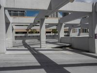 a parking garage with an area for bikes and skateboards to parked with buildings in the background