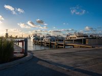 several boats sit docked at a marina during a beautiful day in the city on the water