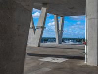 this is a view of some concrete buildings and water and a street sign, taken from the ground