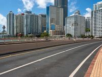 a empty highway with some buildings in the background and an overhang on the other side