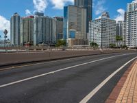 a empty highway with some buildings in the background and an overhang on the other side