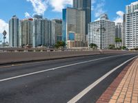 a empty highway with some buildings in the background and an overhang on the other side