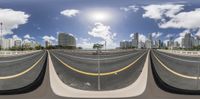 a panorama of a highway with multiple directions to go in front of a high rise city