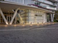 an outside shot of the entrance to a hotel in miami, florida, with lights on