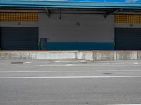 an empty lot with an empty parking lot in the background and clouds in the distance