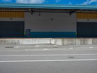 an empty lot with an empty parking lot in the background and clouds in the distance