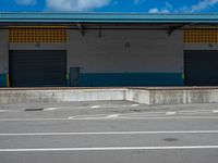 an empty lot with an empty parking lot in the background and clouds in the distance