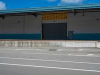 an empty lot with an empty parking lot in the background and clouds in the distance