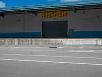 an empty lot with an empty parking lot in the background and clouds in the distance