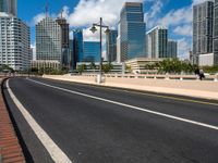 the empty road is running in front of several modern buildings in miami, florida, in the springtime