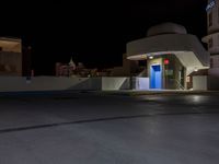 an outdoor parking lot with a fire hydrant and a blue light in the dark