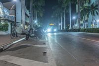 the street is empty with no cars or vehicles on it at night time at some hotels