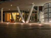 a courtyard outside a building, with a fire hydrant next to it at night