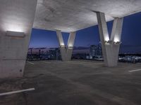 an empty parking lot filled with lots of space at night and lights on the roof