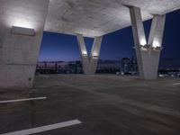 an empty parking lot filled with lots of space at night and lights on the roof