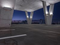 an empty parking lot filled with lots of space at night and lights on the roof