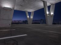 an empty parking lot filled with lots of space at night and lights on the roof