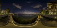 the view of a city from a park at night time from a fisheye lens