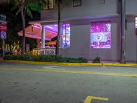 an outside photo of a restaurant at night with neon signs on the side of the building