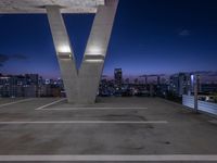 a tall white letter v sits on top of a roof above a city at night