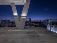 a tall white letter v sits on top of a roof above a city at night