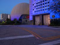 this is a nighttime scene outside of the science center building in long beach, california