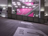 a stairway going up to several different platforms in a building with a bright pink wall