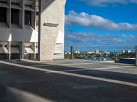 a view from inside a parking garage of the city and its surroundings, with the building in the distance