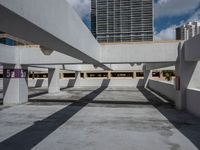 an empty parking garage with concrete columns and open bales on the sides of the building