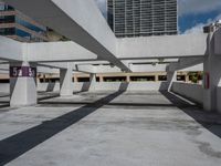 an empty parking garage with concrete columns and open bales on the sides of the building