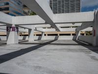 an empty parking garage with concrete columns and open bales on the sides of the building