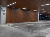 car parking garage with wooden slats and wall signage, and a fire hydrant