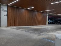 car parking garage with wooden slats and wall signage, and a fire hydrant