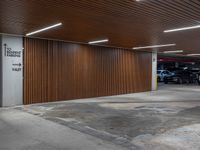 car parking garage with wooden slats and wall signage, and a fire hydrant