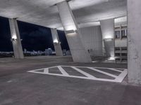 a parking garage with a sky view over cityscape and traffic signs at night