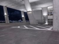 a parking garage with a sky view over cityscape and traffic signs at night