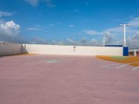 an empty parking lot near several tall buildings in the sky with a sky line on it