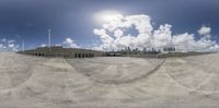 an image of a fish eye view of a parking lot with buildings in the background