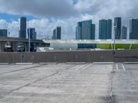 a sky view of a large city skyline and a parking space in a parking lot