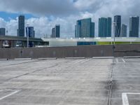 a sky view of a large city skyline and a parking space in a parking lot