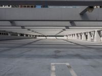 an empty parking lot with no people around it, and large windows in the ceiling