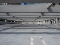 an empty parking lot with no people around it, and large windows in the ceiling