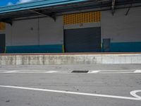 an empty lot with an empty parking lot in the background and clouds in the distance