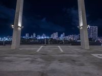 an open parking lot with a large skyline in the back ground and two columns at the bottom