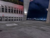 a tall building with lights sitting on top of it at night time in the parking lot