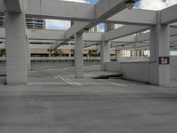 a car park is shown with a parking space in the middle of it and several buildings in the background